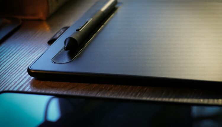 a pen sitting on top of a laptop computer