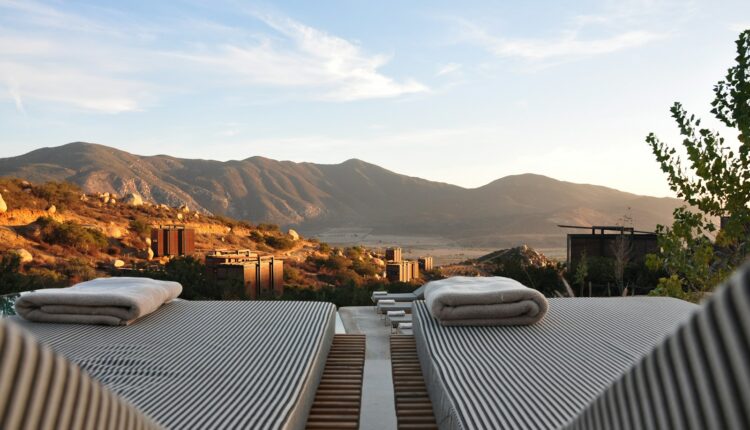sunloungers fronting buildings near mountain